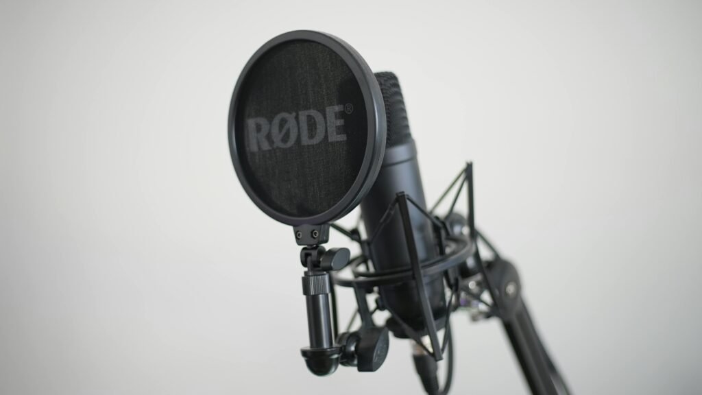 Close-up image of a condenser microphone with pop filter, ideal for music recording.